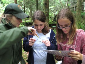 ranger and students examine salamander