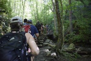 hikers cross wood bridge on Alum Cave Trail