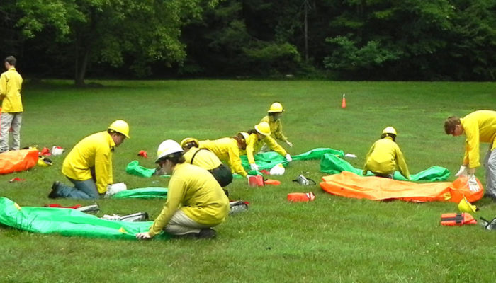 Interns rolling fire shelters