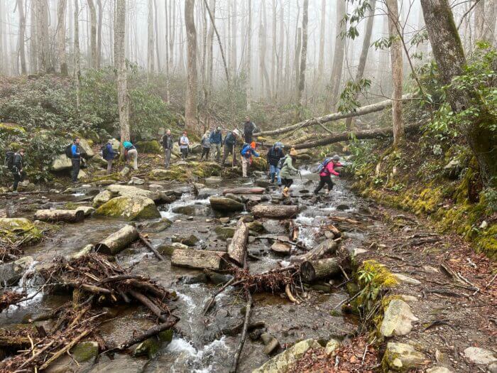 Hikers cross stream on Cucumber Gap Trail