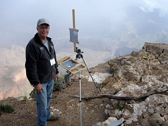 Jake Gaedtke paints on edge of the Grand Canyon