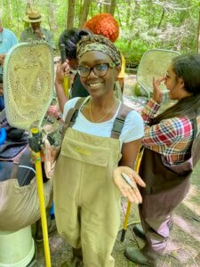 Tuskegee Smokies Experience student holding warpaint shiner fish