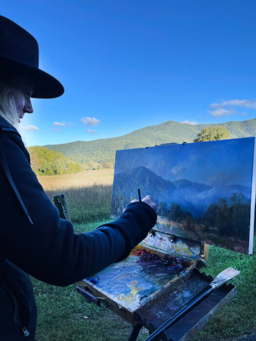 Christine Lashley paints in Cades Cove during Plein Air in the Smokies 2022