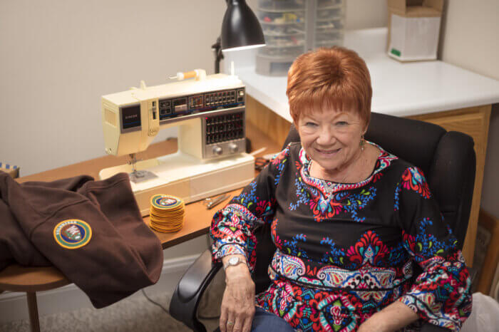 Cindy Metzger-Breeding sitting at her sewing machine