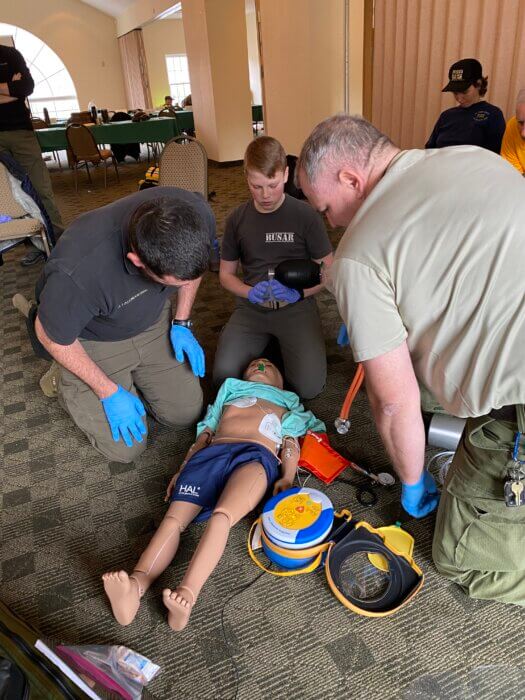Rangers use AED trainer during EMT training