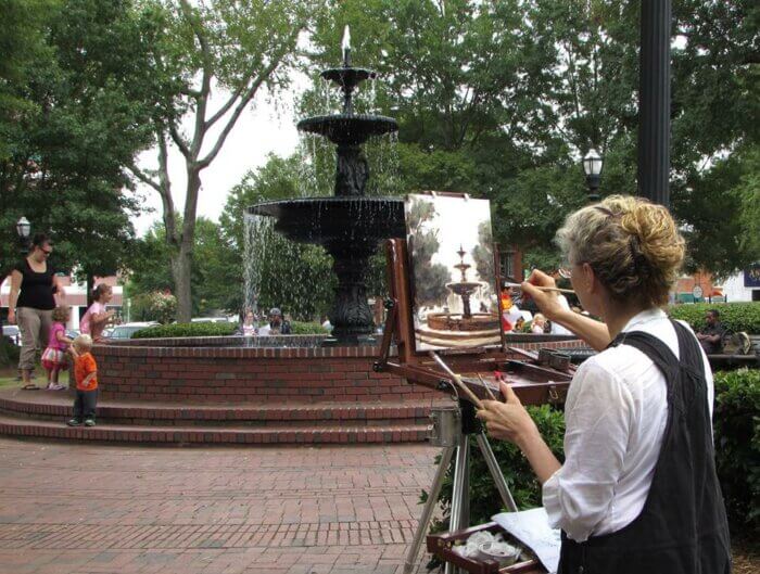 Susan Duke Waters painting a fountain